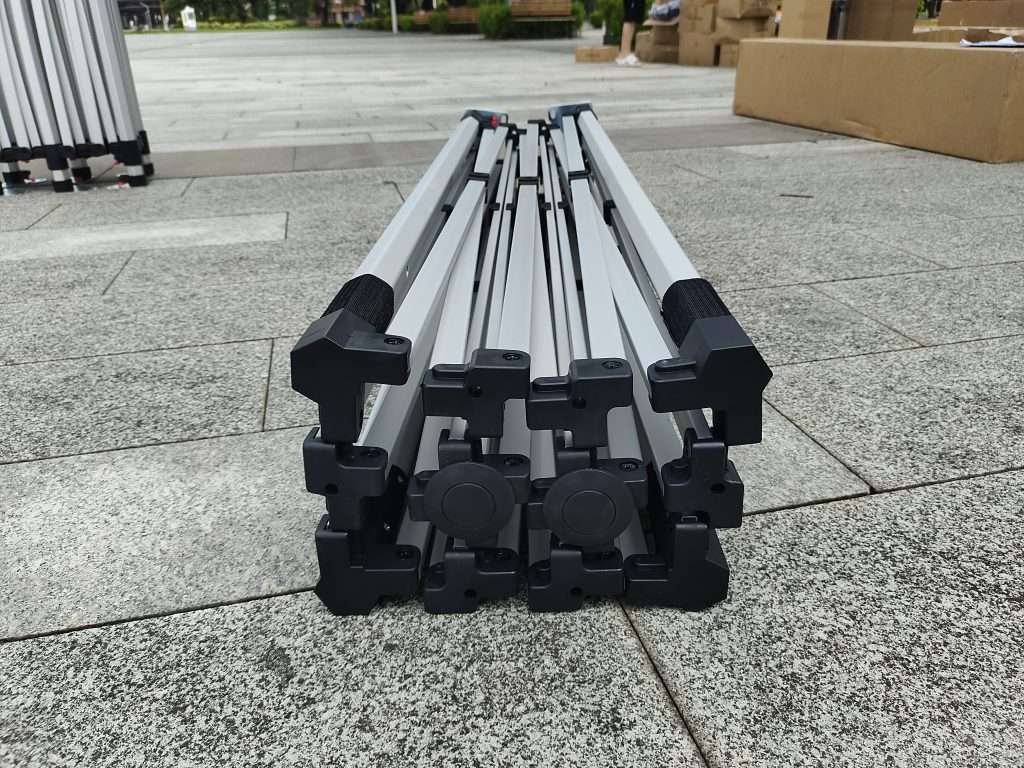 Four metal poles sitting on the ground.