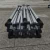 A pile of metal poles sitting on the ground.