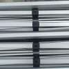 A close up of four metal bars with black handles.