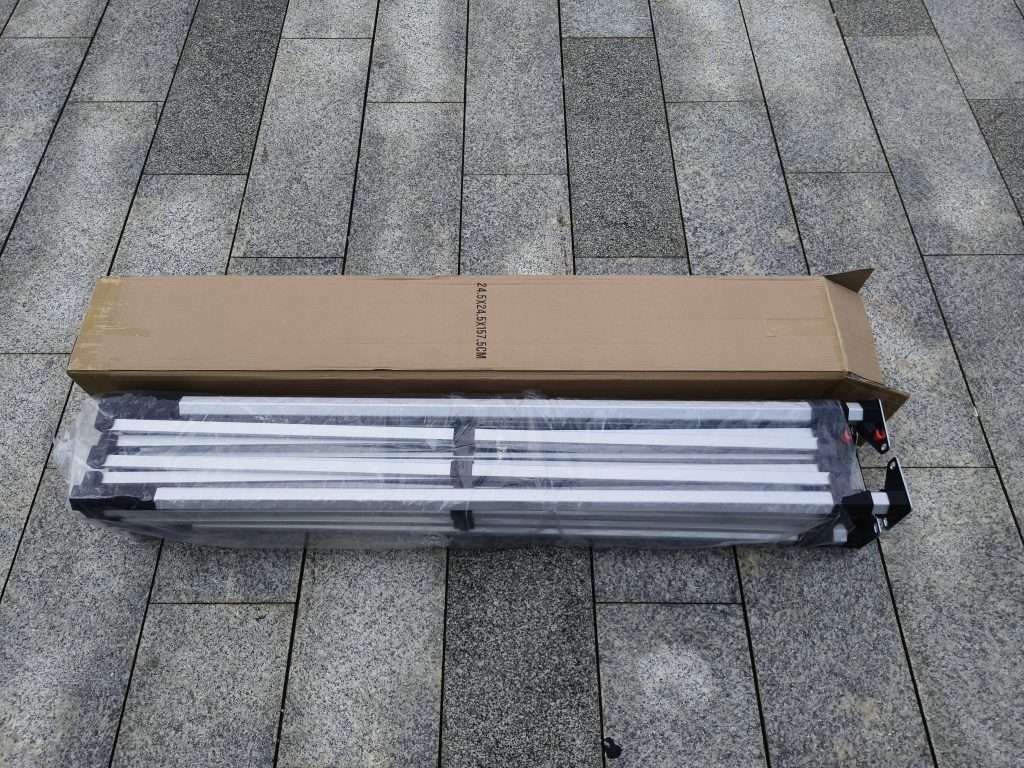A box with four light bulbs sitting on the ground.