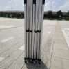 A set of four metal poles sitting on a concrete floor.