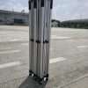 A group of four poles sitting on top of a concrete floor.