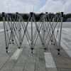 A group of metal poles on a concrete floor.