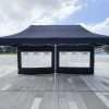 Outdoor tent with two windows and a black canopy.