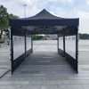 A tent with black fabric on the ground.