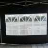 Outdoor tent with black walls and windows.