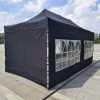 A tent with black walls and windows.