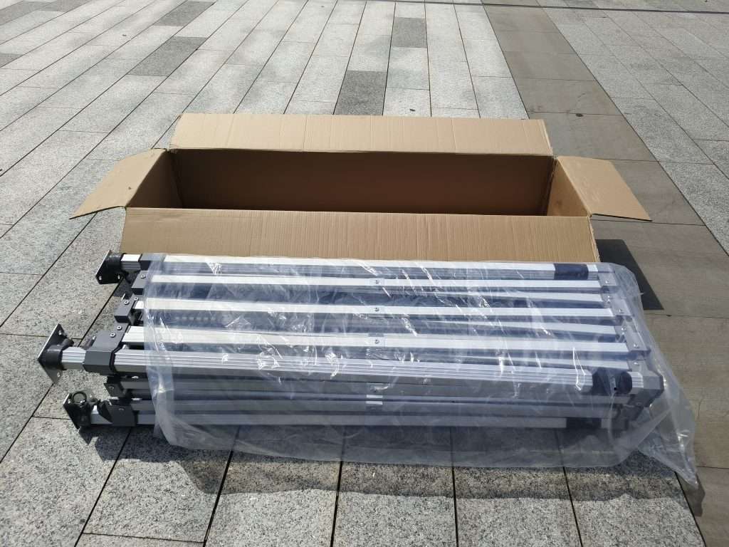 A group of metal poles on a sidewalk.