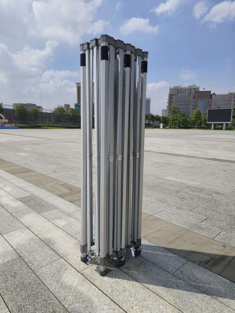 A group of four metal pipes laying on the ground.