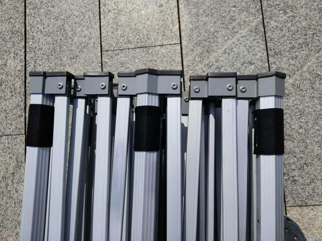 A group of four metal poles sitting on the ground.
