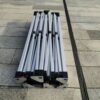 A group of four metal poles sitting on the ground.