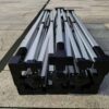 A group of four metal poles sitting on the ground.