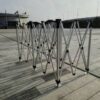 A group of metal poles on a concrete floor.