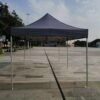 A tent sitting on the ground in a plaza.