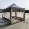 Outdoor pop up tent with awning.