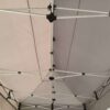 A tent with a metal pole attached to it.