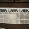 A tent with a white canopy and a black frame.