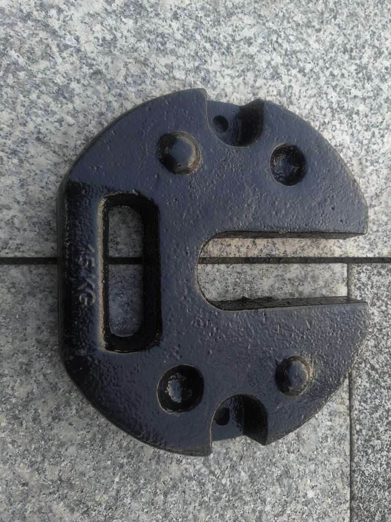 A black metal plate with holes on it.