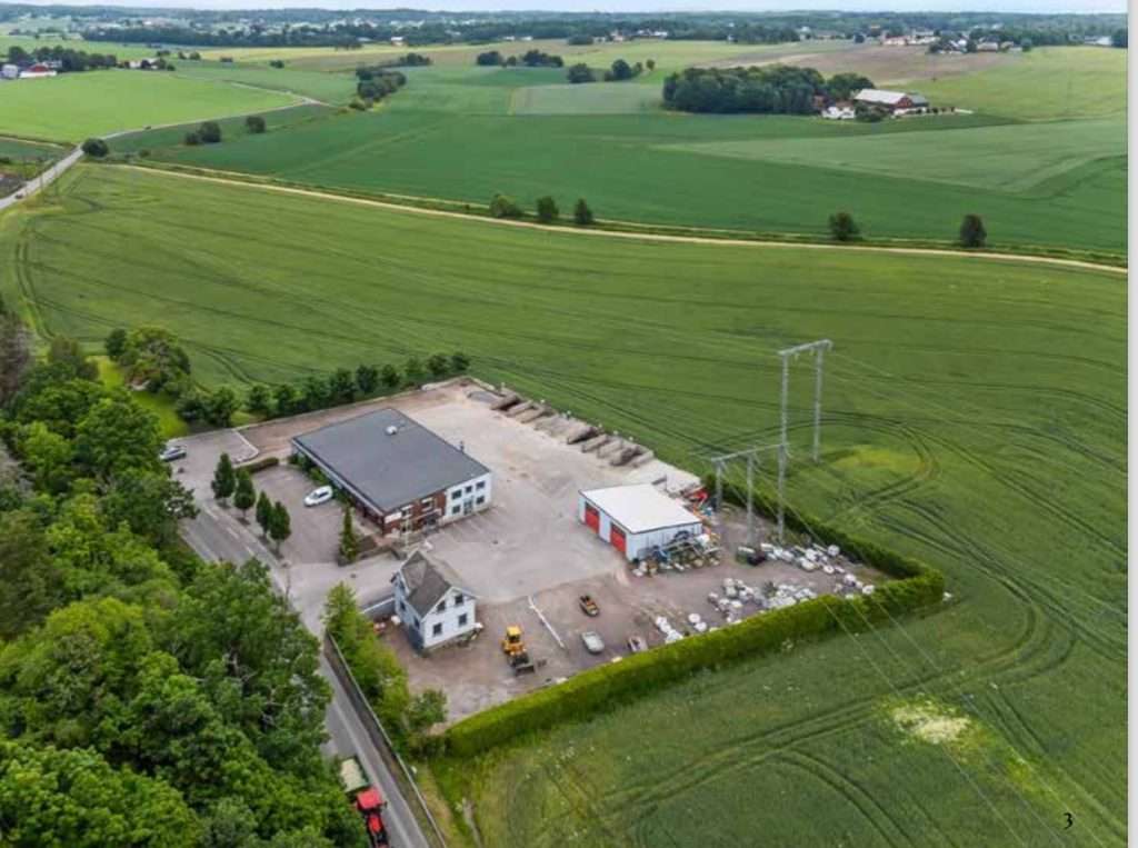 An aerial view of a farm and a power station.