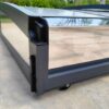 A black and silver metal frame with a glass door.
