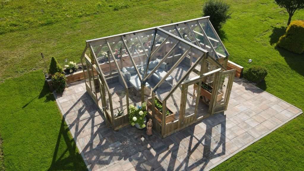 An aerial view of a greenhouse with a patio.
